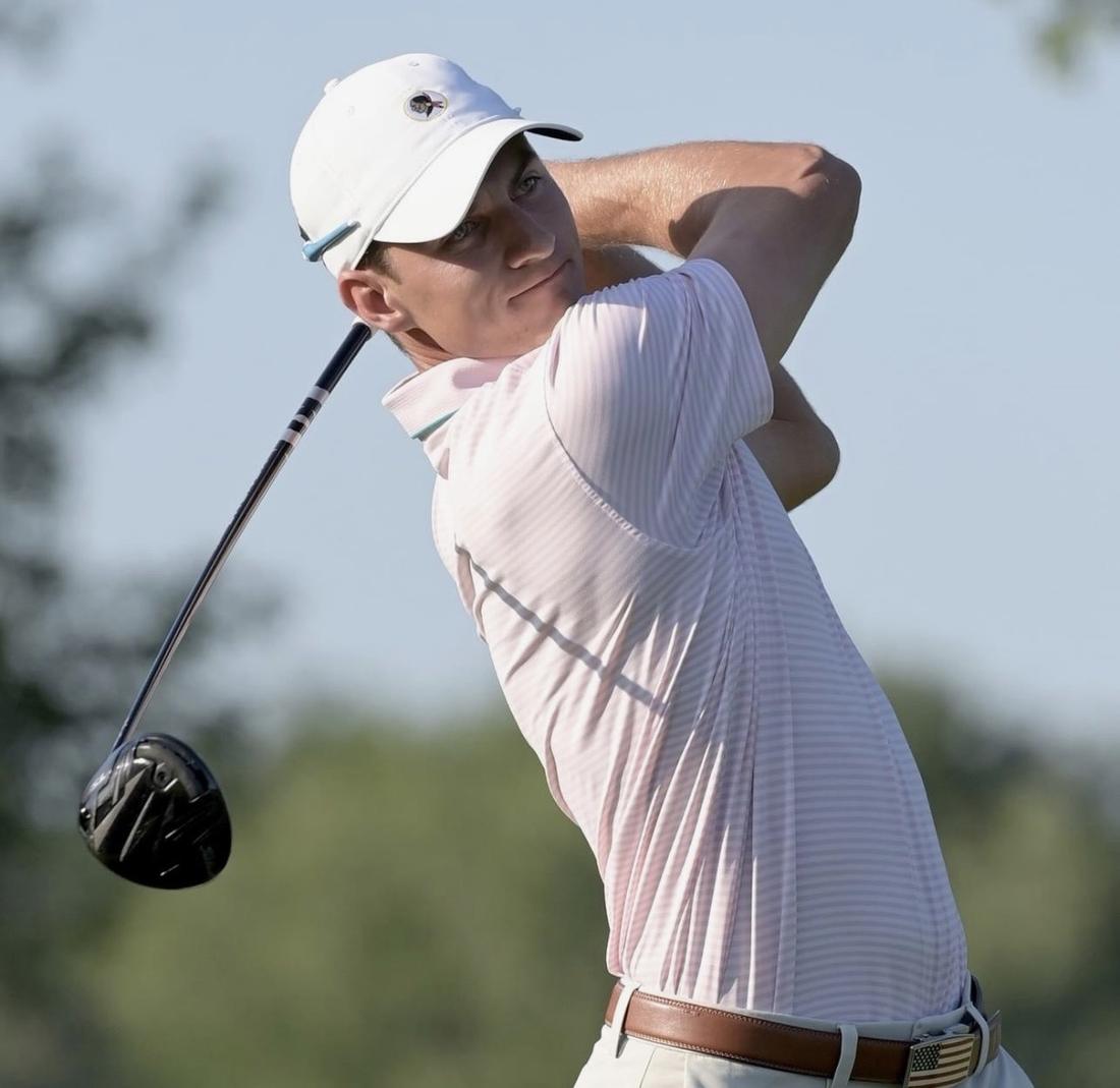 Golfer at the top of the follow-through